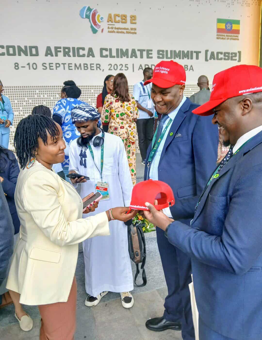 Exchanging words of hope and our red caps to one of vocal climate change activist Elizabeth Wathuti