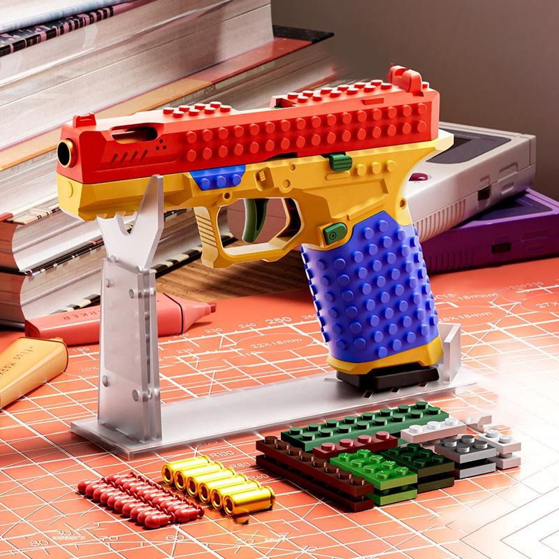 The BlockBlaster on its display stand with spare building bricks and soft rubber tips