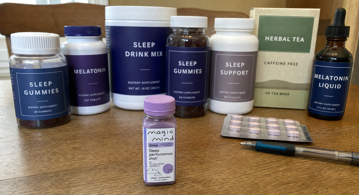 Sleep aids lined up on a table for a label comparison, Magic Mind Sleep among them