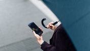 Woman with OANDA Mobile App on her phone