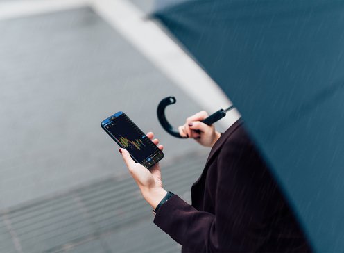 Woman with OANDA Mobile App on her phone
