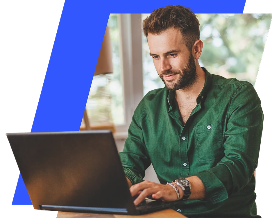 OANDA brand lifestyle image featuring a focused man in a green button-down shirt typing on a laptop, framed within a sharp geometric layout with a bright blue accent stripe.