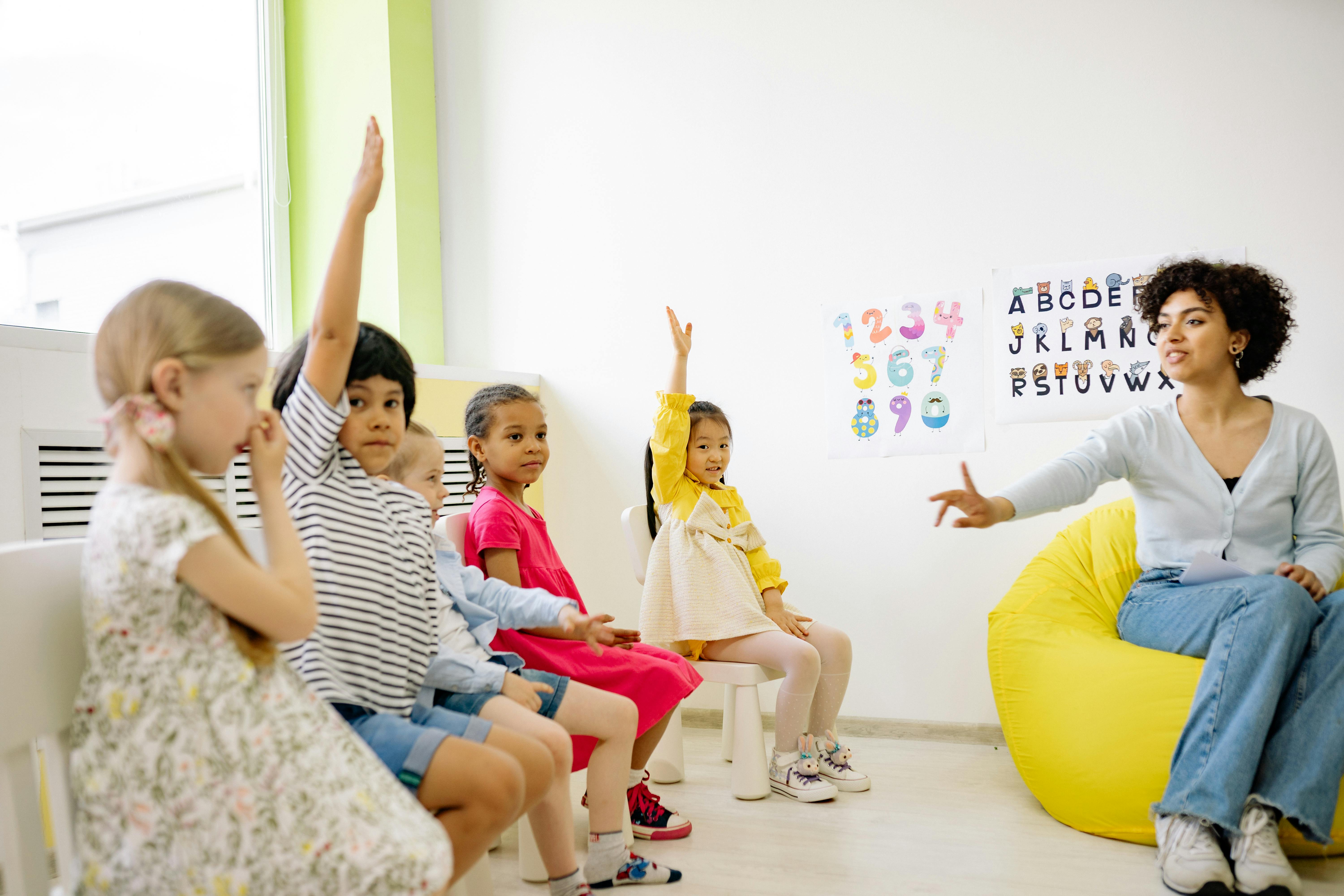 woman teaching with a photo poster behind her