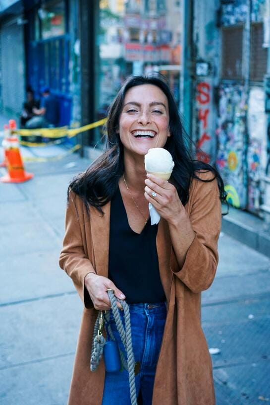 woman laughing with an ice cream