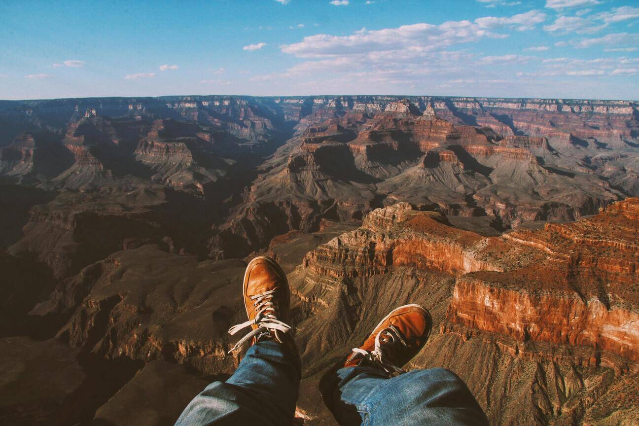 feet in front of the grand canyon