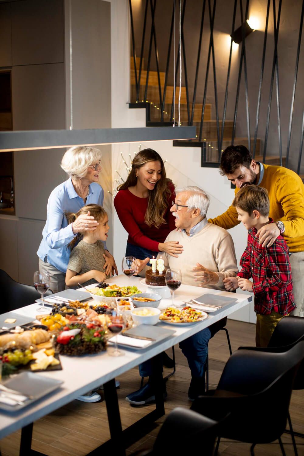 A family laughing together at the dinner table, showcasing the joy of Thanksgiving togetherness.