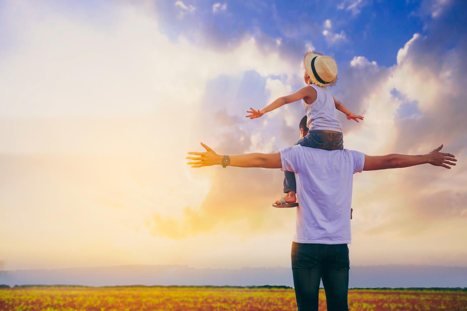 A supportive father with his child on shoulders