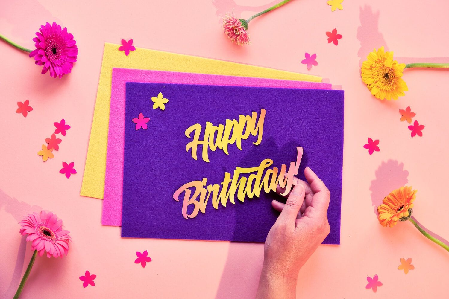 Birthday wishes written on colorful cards.