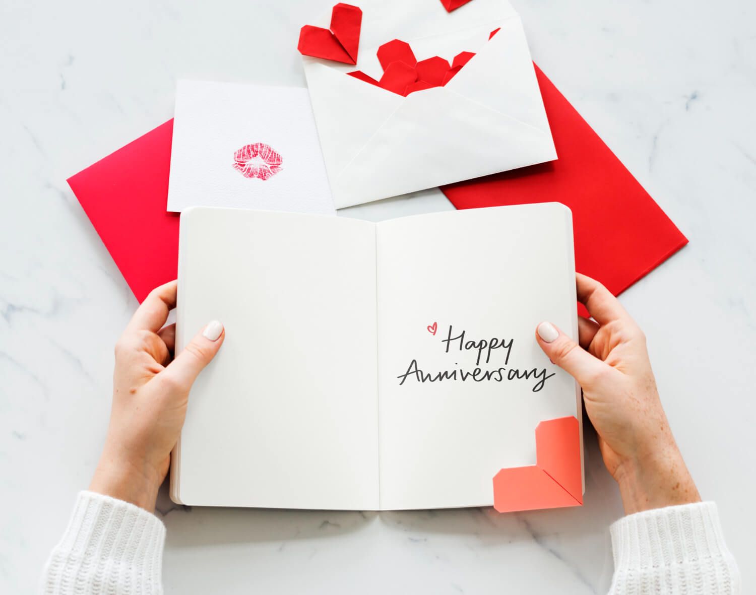 Hands holding anniversary card with romantic text.jpg