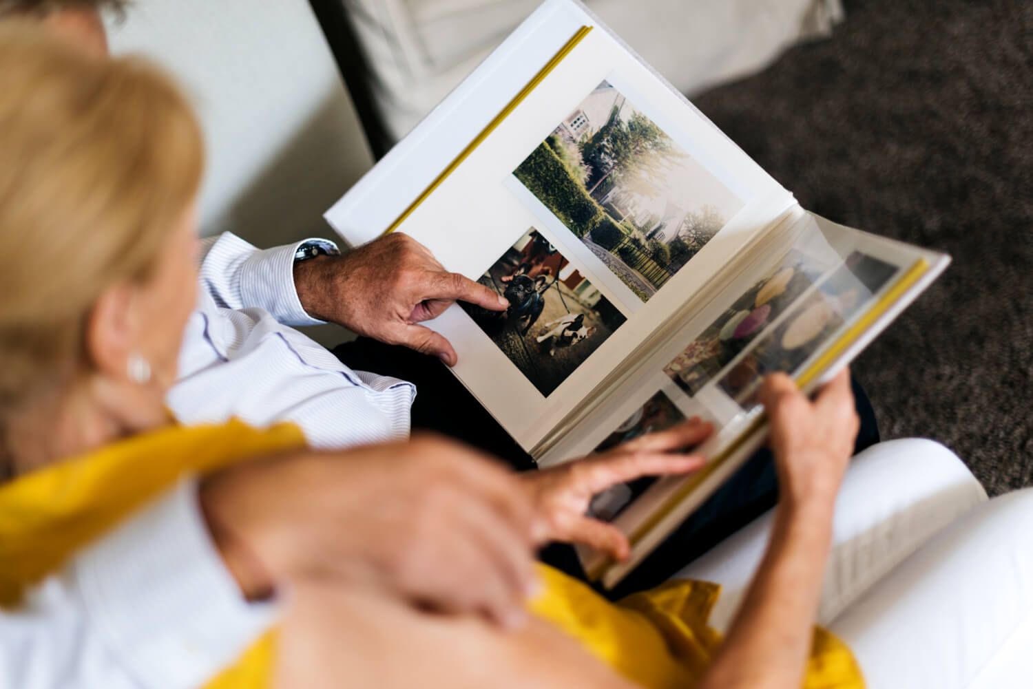 Open photo book displaying various personal images with a windowed cover.jpg