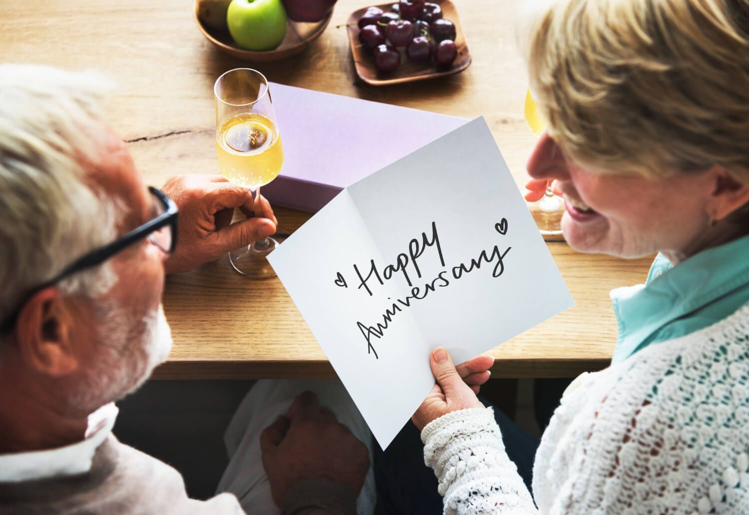 Parents reading an anniversary card