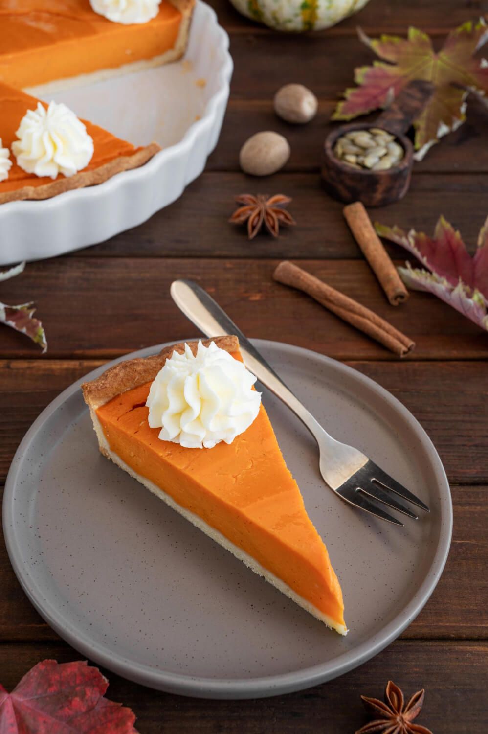 Pumpkin pie slice with whipped cream