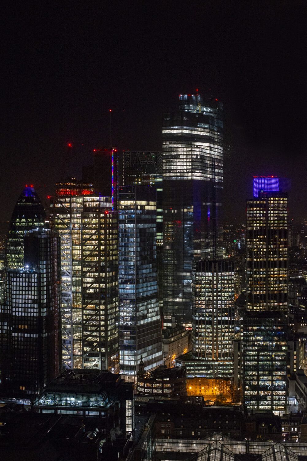 Reflective metal panel print of a city skyline at night