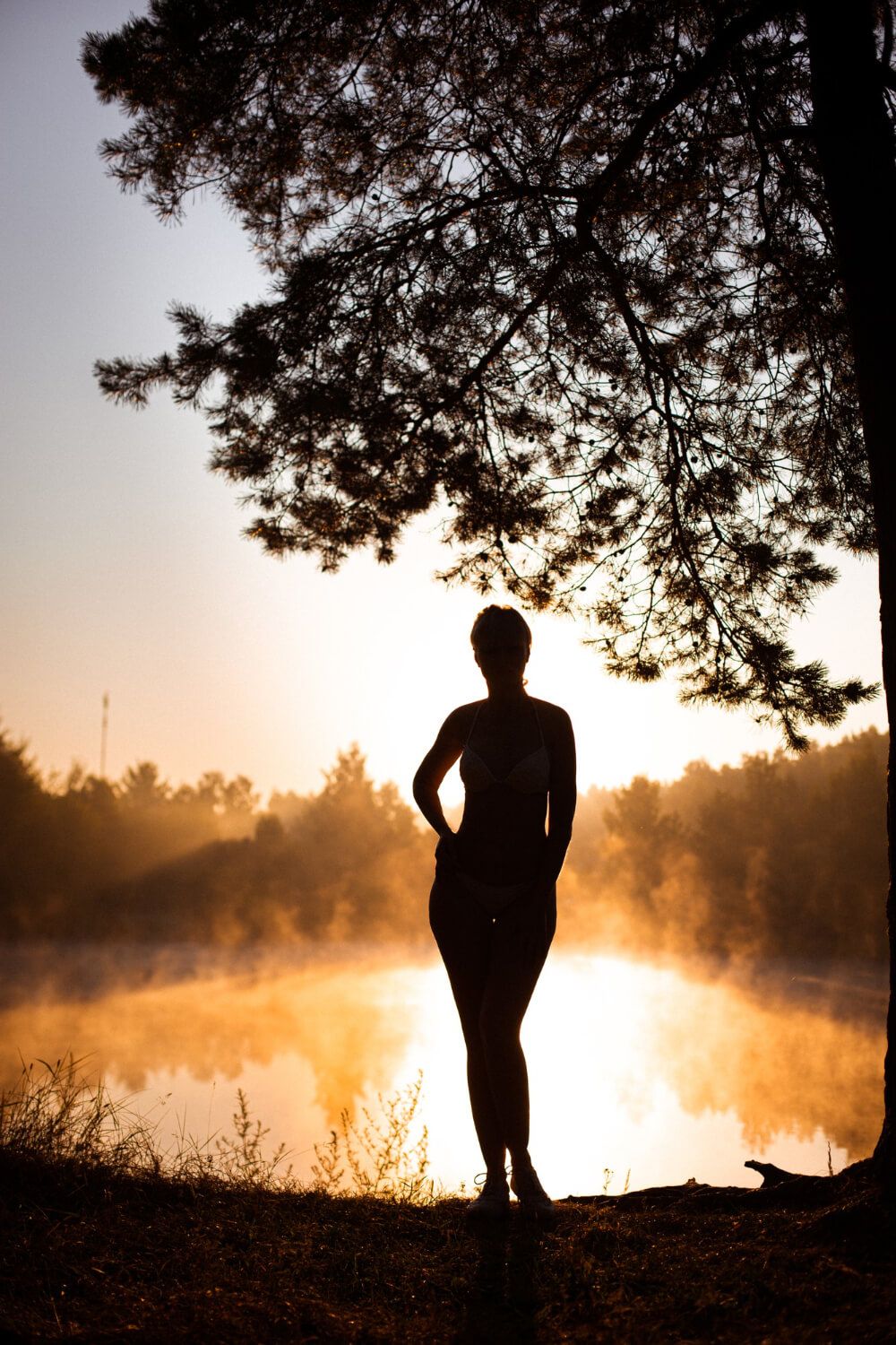 Silhouette of a person standing in the shadows with sunlight nearby