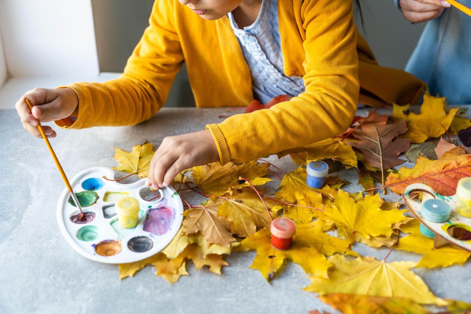 Thanksgiving craft made by kids, depicting a turkey using handprints