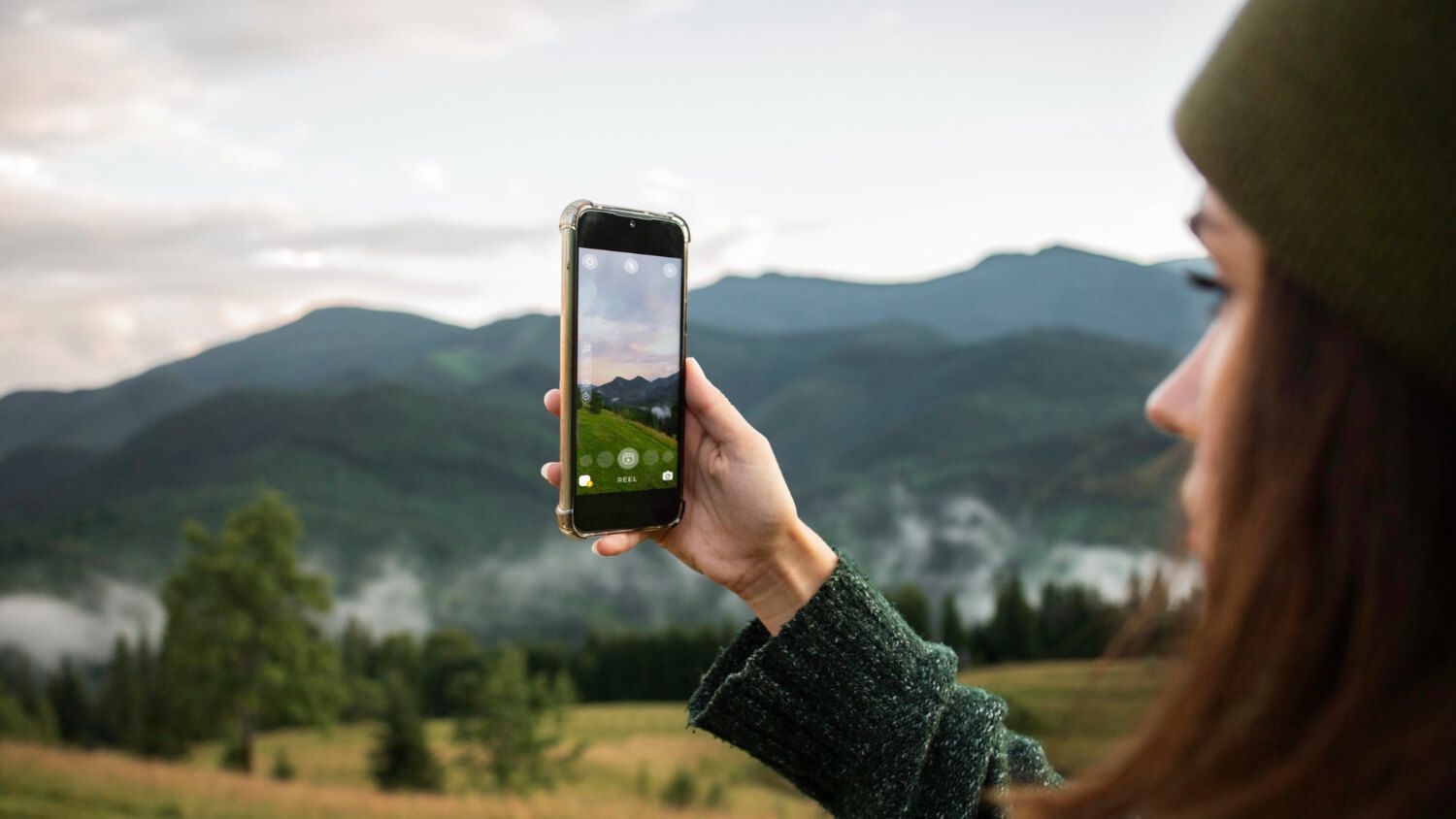 Tourist capturing a scenic view on a smartphone