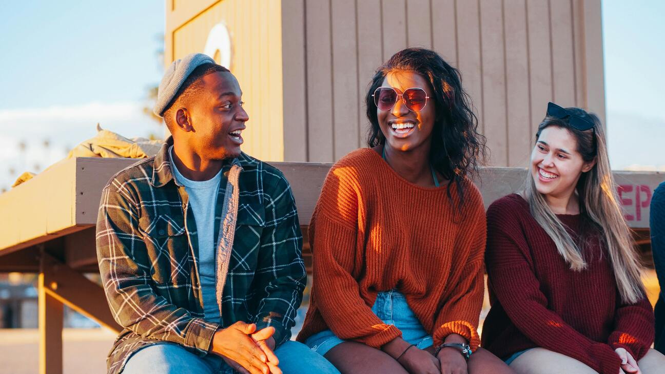 friends smiling on a rooftop