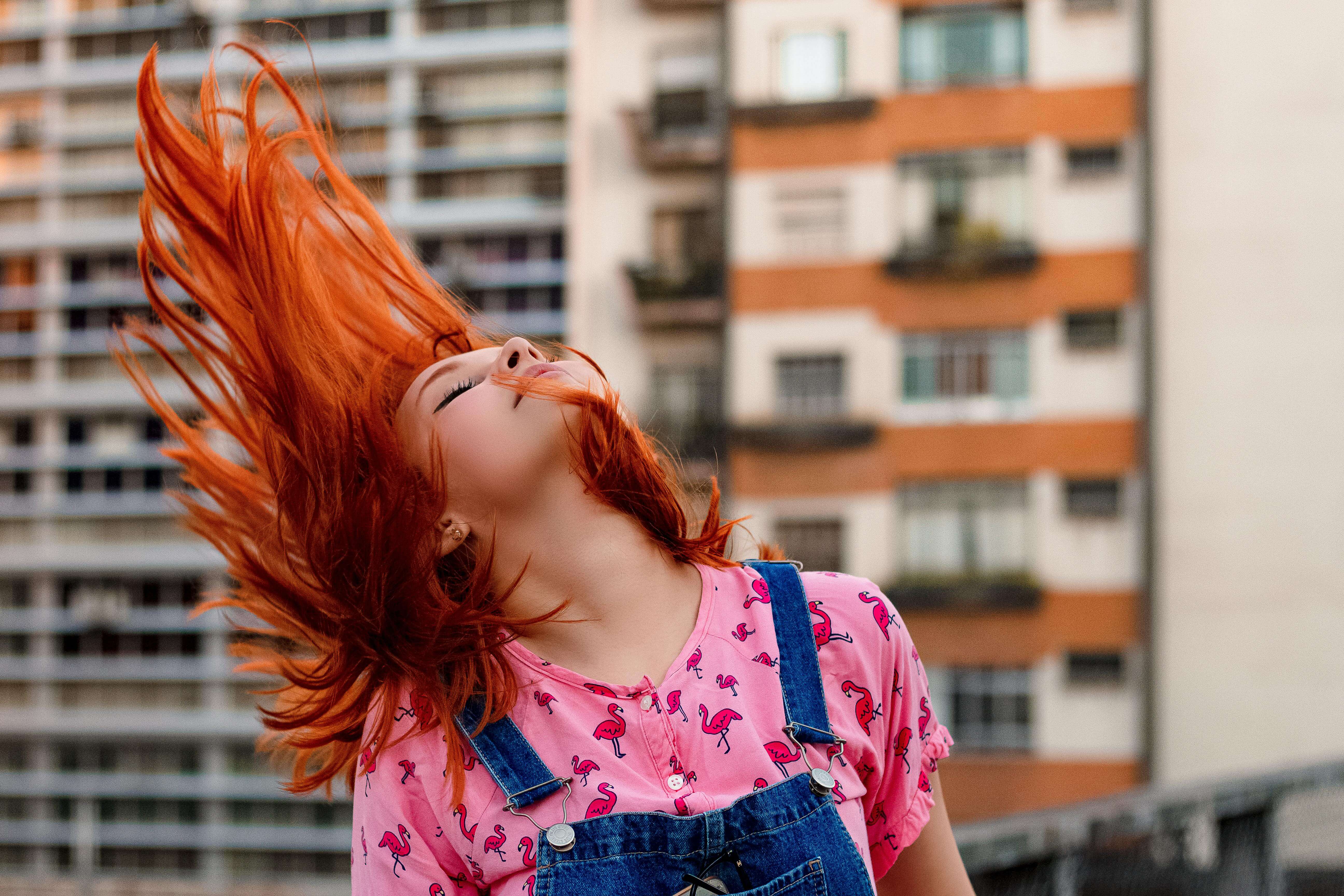 red-headed woman flipping her hair
