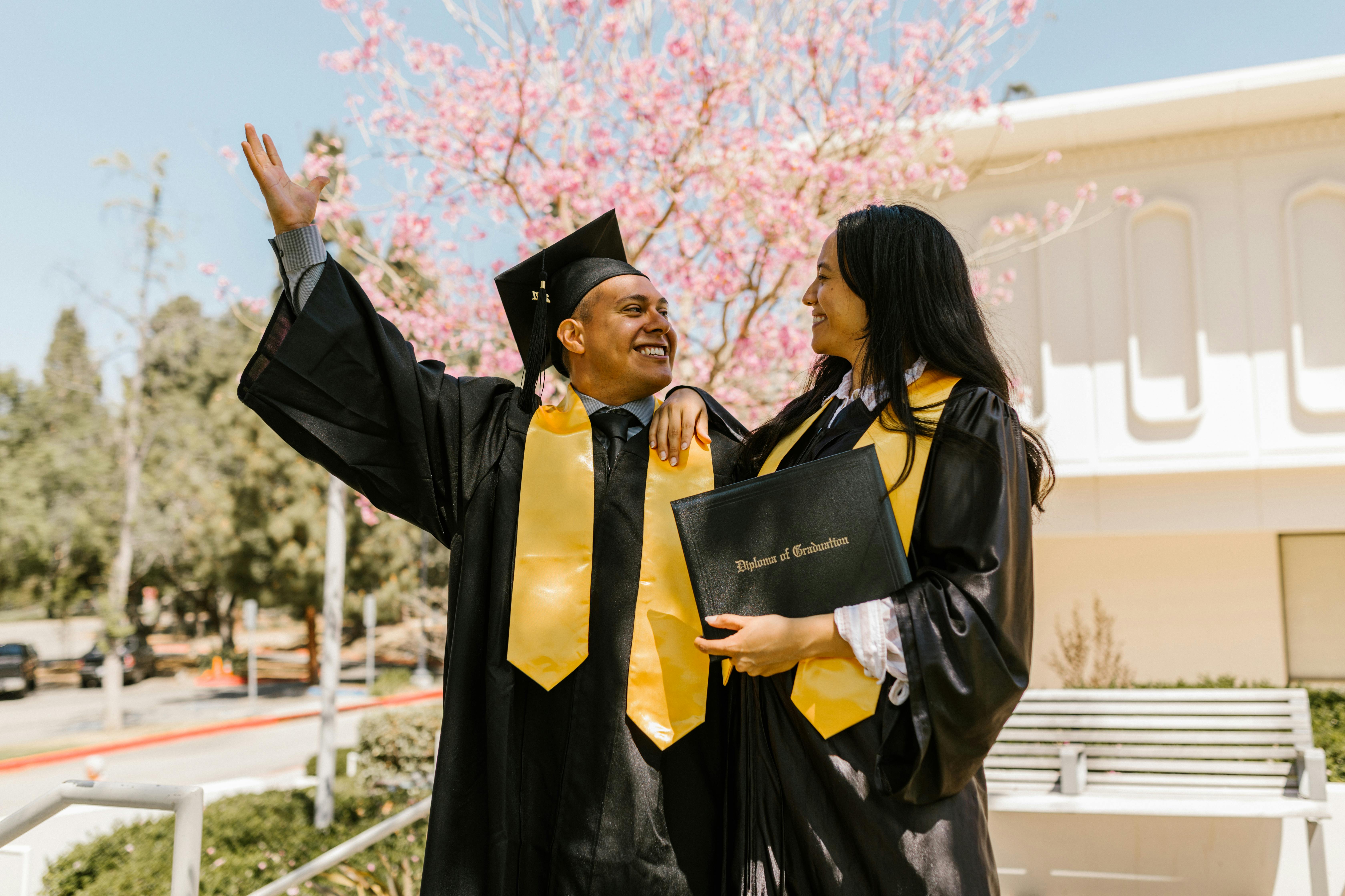 girl and boy graduation with diploma