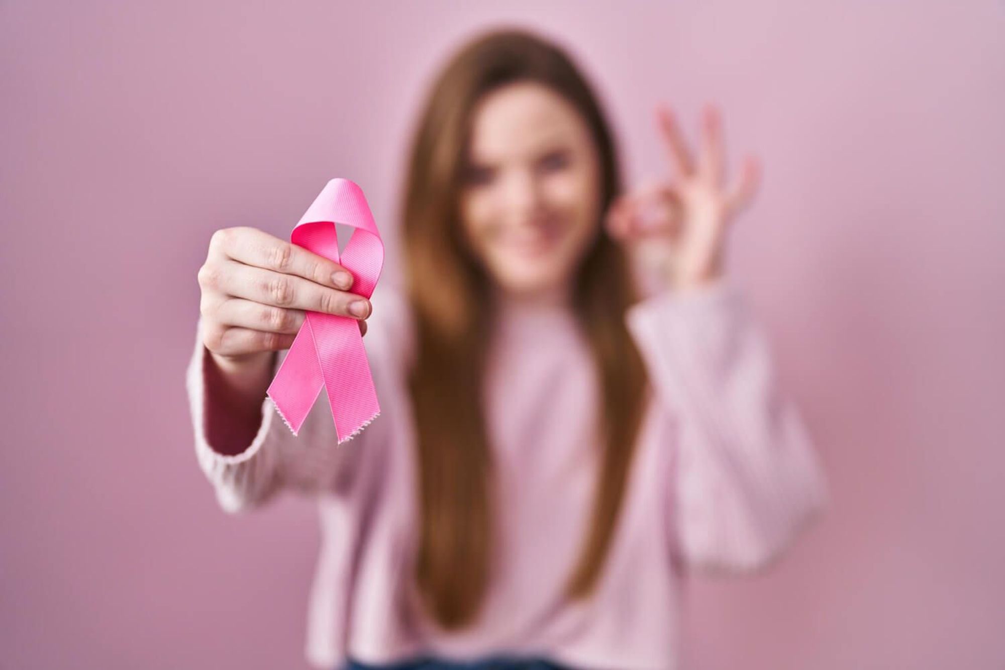 girl holding pink ribbon