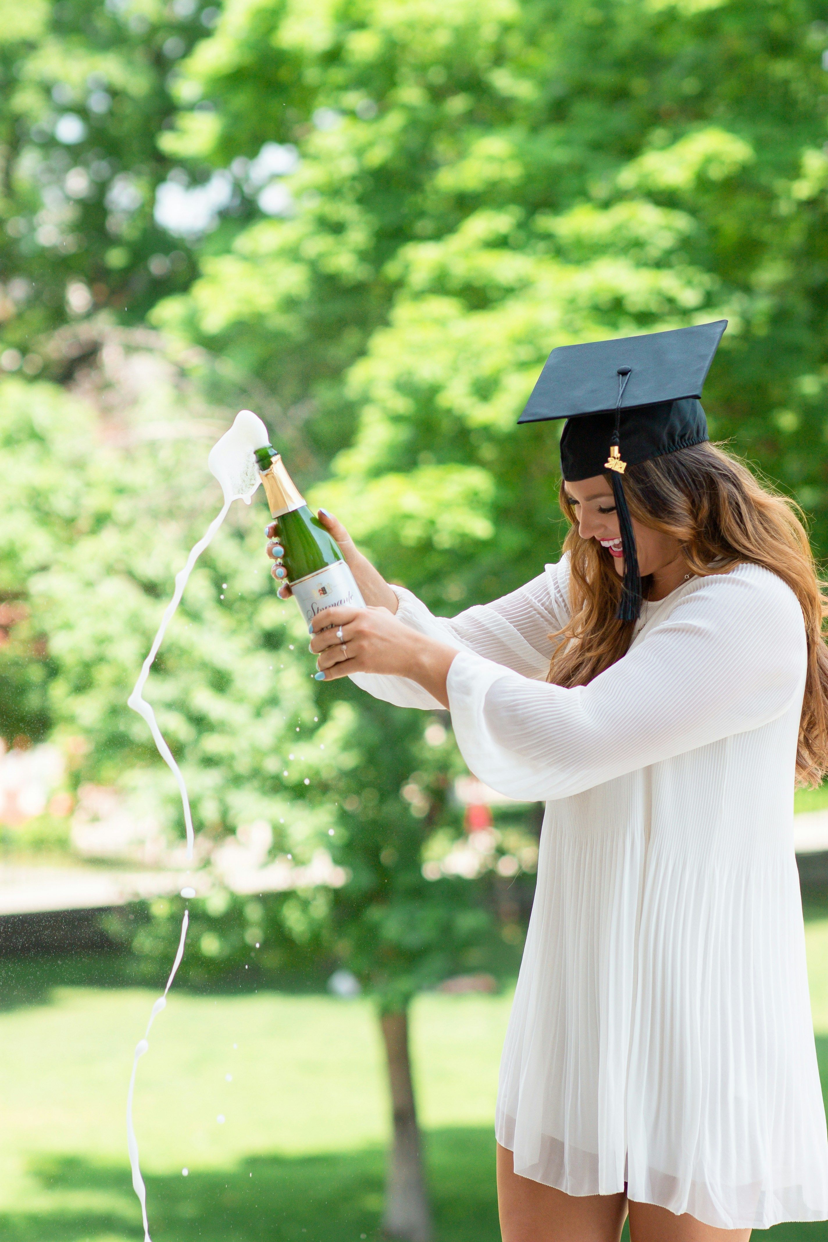 girl with graduation cap and champagne bottle