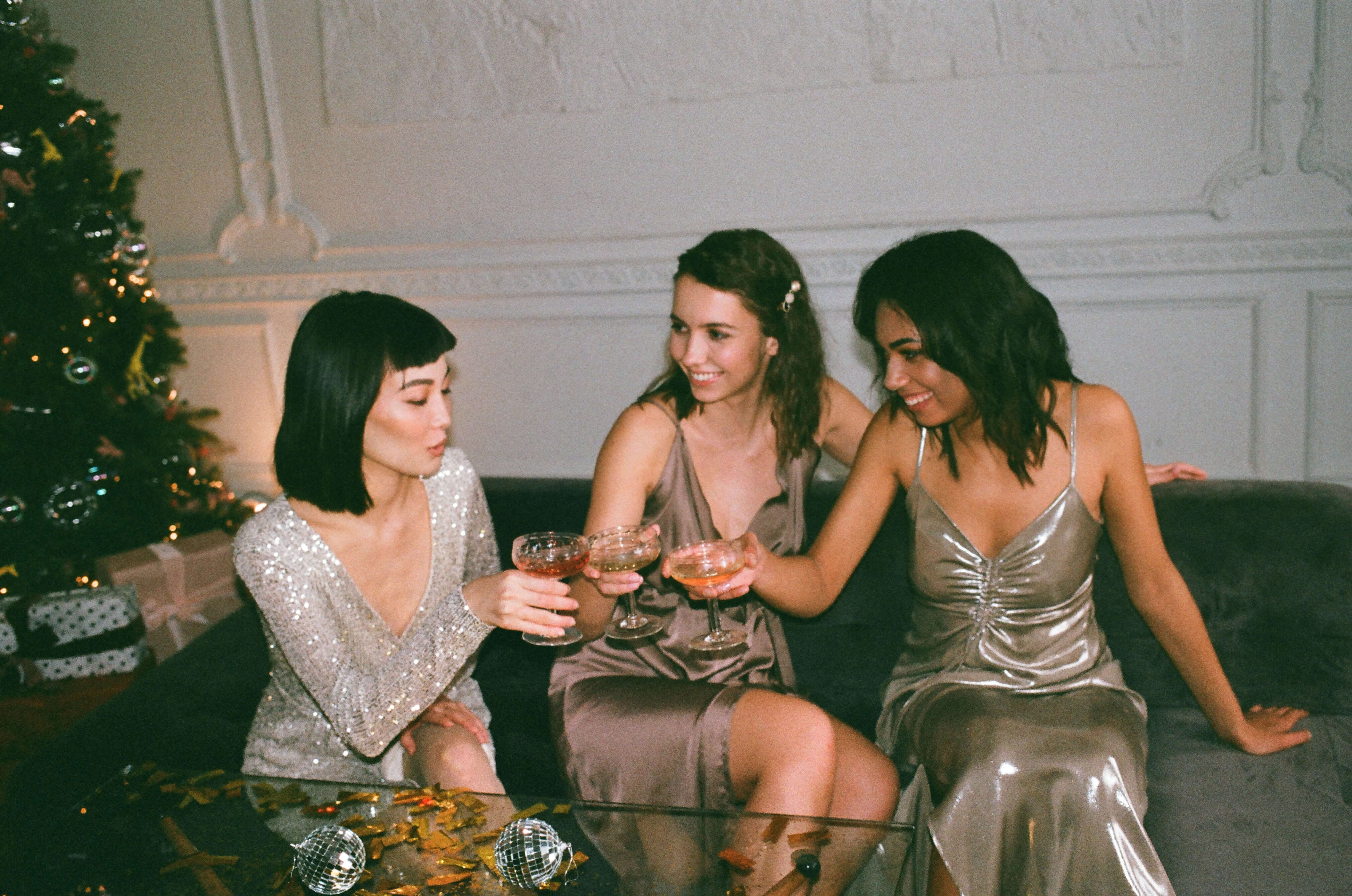 women toasting with champagne in sparkly dresses