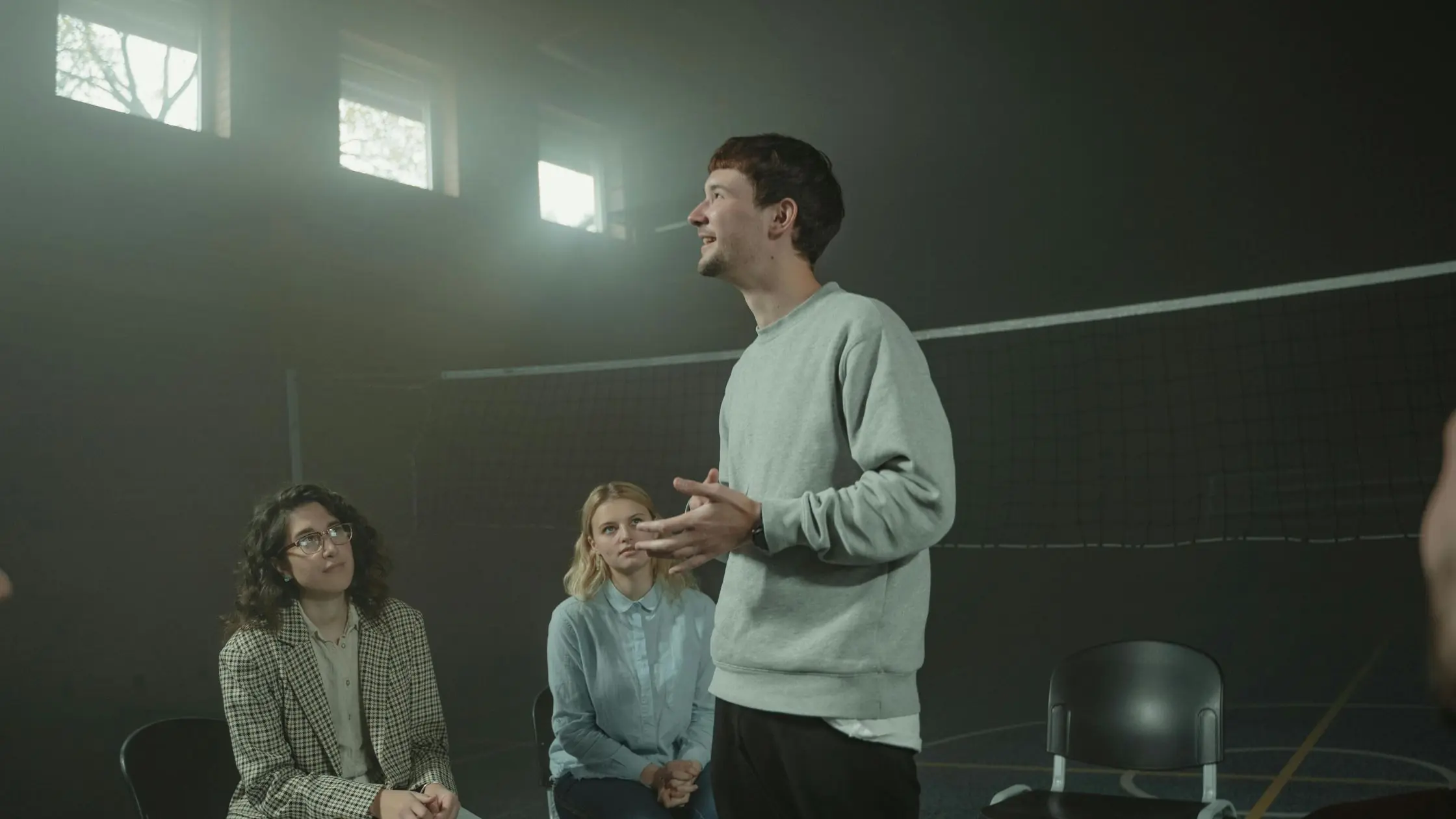 A man speaking in the middle of a support group