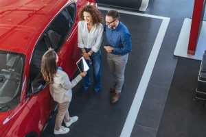Young couple in a dealership buying a GM vehicle