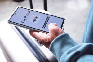 Closeup on an iPhone with a rental car app open
