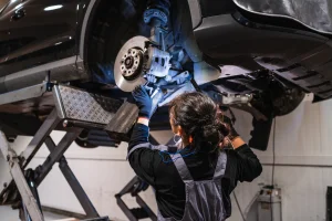 Mechanic working on a car on a lift