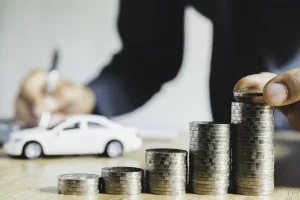 Graphic depicting the cost of an extended warranty with stacks of change and a toy car