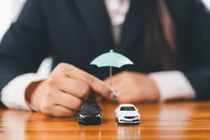 graphic of an umbrella held up over two toy cars