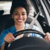Happy woman driving a car