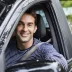 Happy male driver in a car who bought an auto warranty direct from Cuvrd