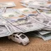 Model car covered by $100 US bills signifying auto warranty prices
