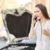 Upset woman calling insurance on phone after car breakdown on the street