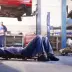 mechanic under car performing routine maintenance