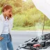 Woman stranded on the side of the road calling a tow truck after her car overheated