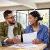 Young couple checking their credit scores before refinancing their car loan