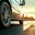 side view of a car with an exclusionary auto warranty speeding down the highway