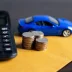 Picture of a blue toy car, calculator, and change representing an extended warranty cost estimate