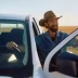 Happy farmer getting into his pick-up truck covered with an extended warranty