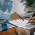 Customer signing a lease buyout loan contract that includes a warranty and taxes