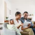 young couple buying an online extended warranty on their sofa