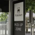 Black and white rideshare pick-up zone sign