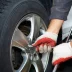 closeup of tire being changed on a silver vehicle