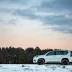 White Toyota Land Cruiser in a snowy field