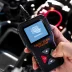 OBDII Scanner in use under the hood by auto mechanic for reading fault code of the car engine system