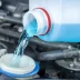 Closeup of a windshield washer fluid tank being filled
