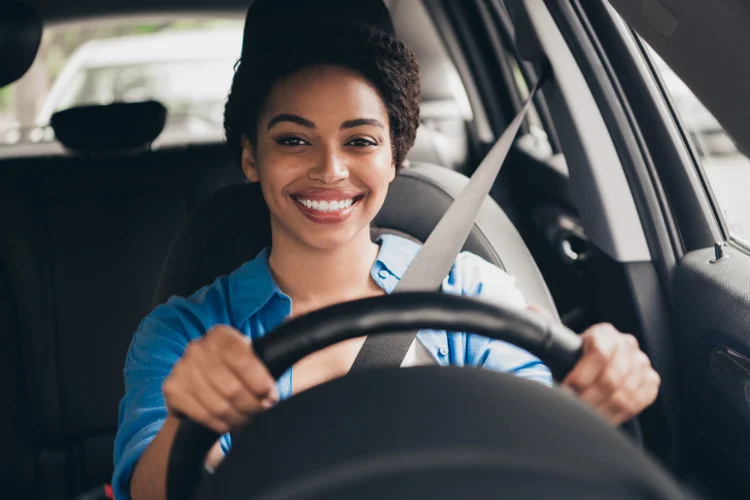 Happy woman driving a car
